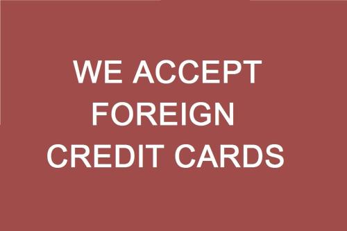 a sign that says we accept foreign credit cards at Oktiabrskaya Hotel in Saint Petersburg