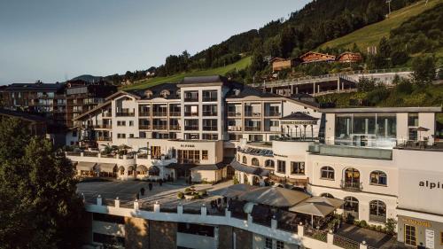 an aerial view of a hotel with a mountain at Alpina Alpendorf in Sankt Johann im Pongau