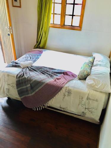 a bed with a blanket on it in a room at Igula lodge in Mkuze