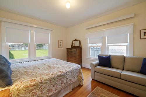 a bedroom with a bed and a couch and windows at Family & Dog Friendly 4BR in Downtown NE Harbor - Millbrook in Northeast Harbor