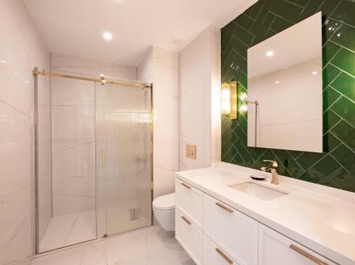 a bathroom with a shower and a sink and a toilet at Homie Suites - Newly Built Seaside Apartments on Bakırköy Shore in Istanbul
