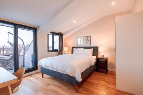 a bedroom with a bed and a large window at Homie Suites - Newly Built Seaside Apartments on Bakırköy Shore in Istanbul