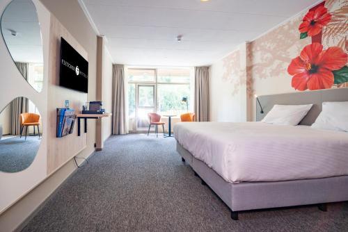 a hotel room with a bed and a table and chairs at Fletcher Hotel-Restaurant De Scheperskamp in Lochem