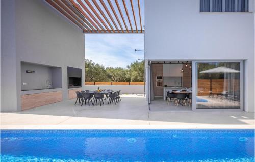 a house with a swimming pool next to a house at Villa Activia in Sveti Filip i Jakov