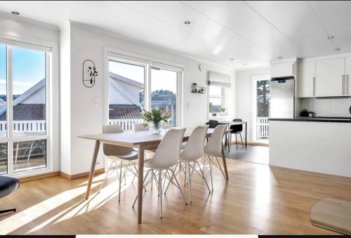 a kitchen and dining room with a table and chairs at Nydelig hus med utsikt in Kristiansand
