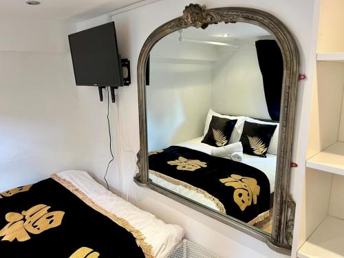 a bedroom with a mirror and a bed at Pass the Keys Cosy one bed flat with parking and scenic views in Rickmansworth
