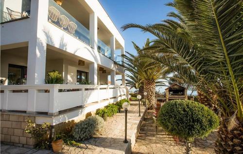 a white building with palm trees in front of it at Villa Sunset Loft in Vir