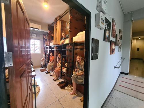 a group of children sitting in a room at The 8 Factory Hotel Phitsanulok in Phitsanulok