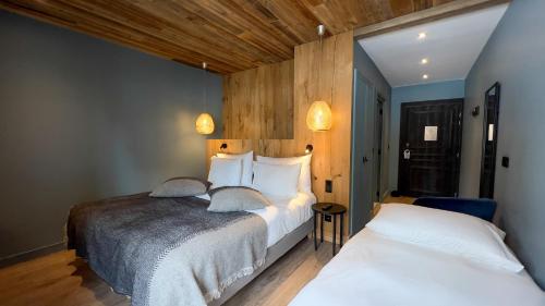 Ένα ή περισσότερα κρεβάτια σε δωμάτιο στο Hotel MONT-BLANC VAL D'ISERE