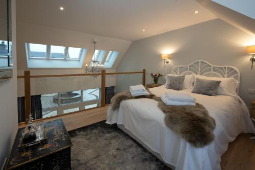 a bedroom with a large white bed with a faux fur sqor at Kipney Hunting Lodge in Perth