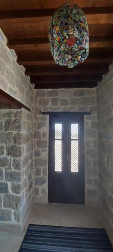 a room with a black door and a window and a chandelier at palm shadow resort in Tunis