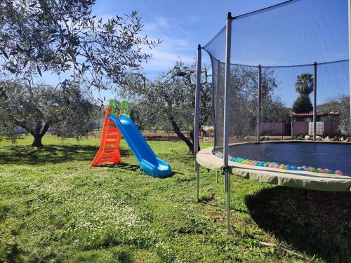 a playground with a slide next to a pool at Il Nido in Fiano Romano