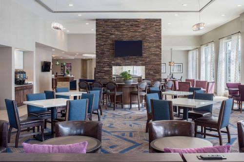 a restaurant with tables and chairs and a fireplace at Homewood Suites By Hilton New Orleans French Quarter in New Orleans