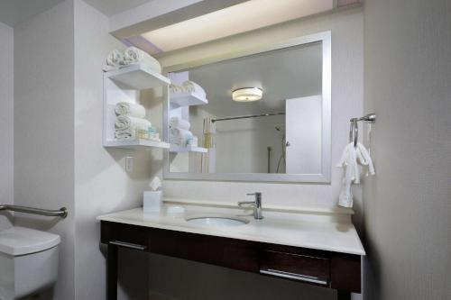 a bathroom with a sink and a mirror at Hampton Inn Martinsville in Martinsville