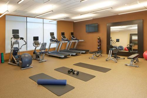 a gym with several treadmills and exercise equipment at Hilton Garden Inn Boston/Marlborough in Marlborough