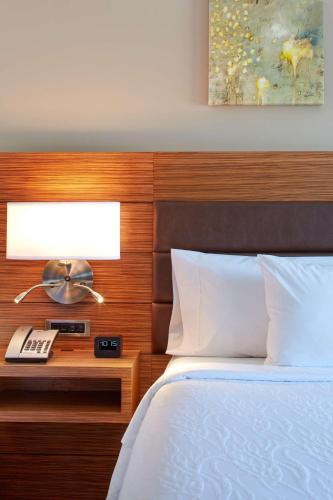 a bedroom with a bed with a wooden head board at Hilton Garden Inn Boston/Marlborough in Marlborough