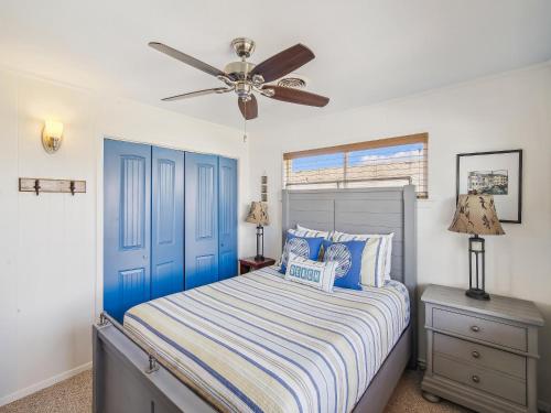 a bedroom with a bed and a ceiling fan at Celestial Dreams in Galveston