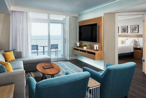 a living room with a room with a bed and a television at Hilton Grand Vacations Club Ocean Enclave Myrtle Beach in Myrtle Beach