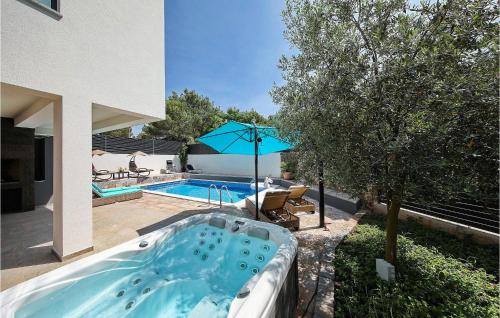 a hot tub in the yard of a house at Villa Mara in Zaton