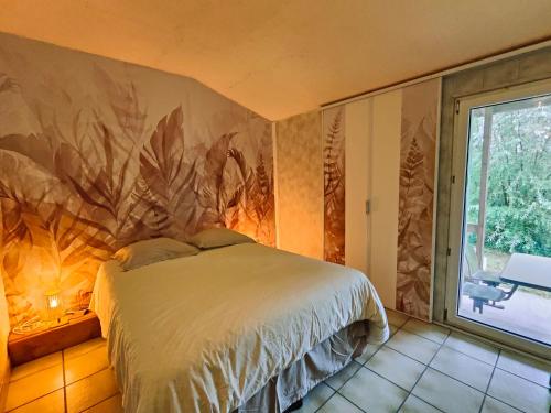 ein Schlafzimmer mit einem Bett und einem großen Fenster in der Unterkunft le Moulin des Moines in Châtenois