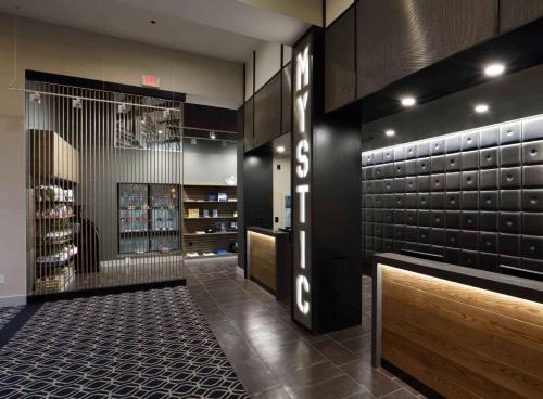 a room with a wine cellar with a wine bottle display at Hilton Mystic in Mystic
