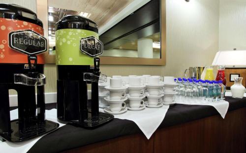 a table with bottles and glasses on top of it at Hilton Garden Inn New York/Midtown Park Avenue in New York