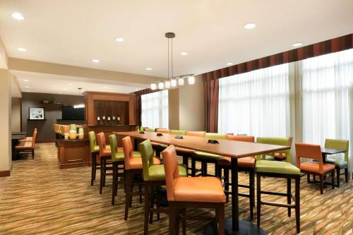 a conference room with a long table and chairs at Hampton Inn New York - LaGuardia Airport in Queens