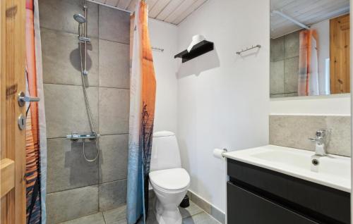 a bathroom with a shower and a toilet and a sink at Stunning Home In Haderslev With 4 Bedrooms And Wifi in Diernæs