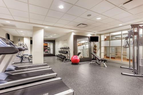 a gym with treadmills and machines in a room at Hampton Inn Manhattan Grand Central in New York