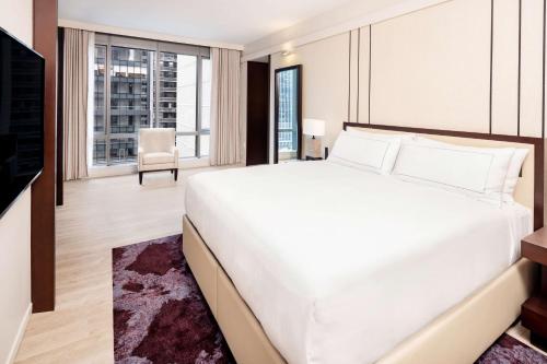 a bedroom with a large white bed and a large window at Hilton Club West 57th Street New York in New York