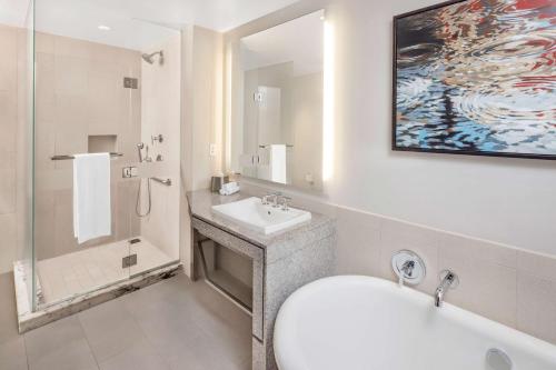 a bathroom with a sink and a toilet and a tub at Hilton Club West 57th Street New York in New York