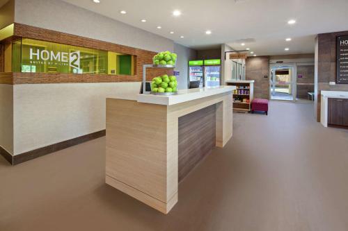 a lobby of a home pharmacy with apples on a counter at Home2 Suites By Hilton Alameda Oakland Airport in Alameda