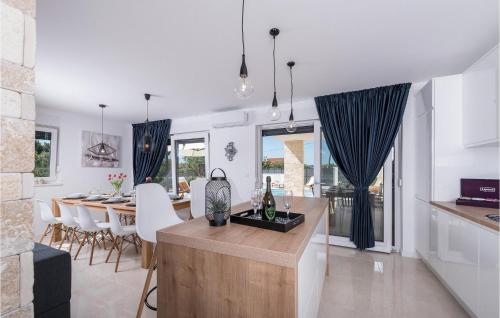 a kitchen and living room with a table and chairs at Villa Oasis in Sukošan