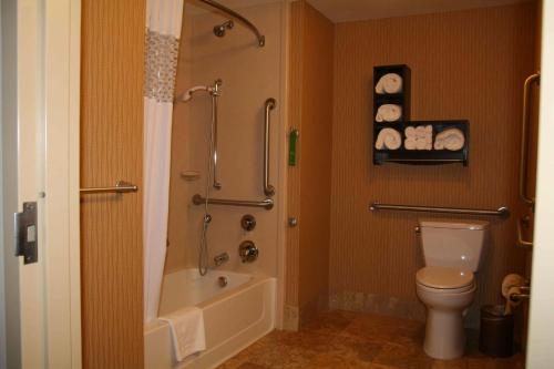 a bathroom with a shower and a toilet and a tub at Hampton Inn Union City in Union City