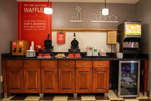 a counter in a coffee shop with aasteryasteryasteryasteryasteryasteryasteryastery at Hampton Inn & Suites Jacksonville in Jacksonville
