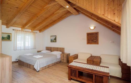 a bedroom with two beds and a couch and a table at Villa Luka Brac in Ložišće