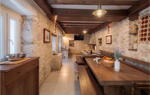 a kitchen with stone walls and wooden counters at Villa Luka Brac in Ložišće