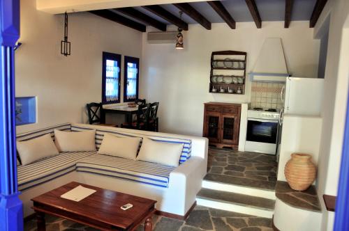 a living room with a couch and a table at Nefeli Hotel Leros in Agia Marina