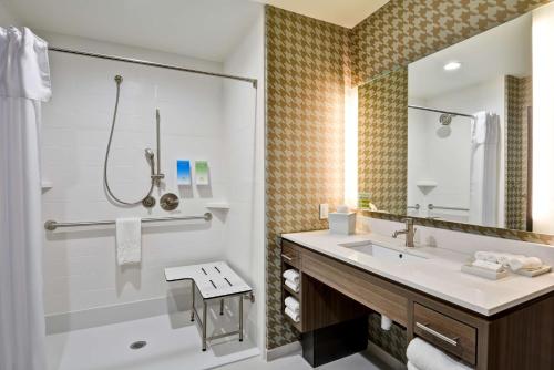 a bathroom with a sink and a shower at Home2 Suites by Hilton OKC Midwest City Tinker AFB in Midwest City