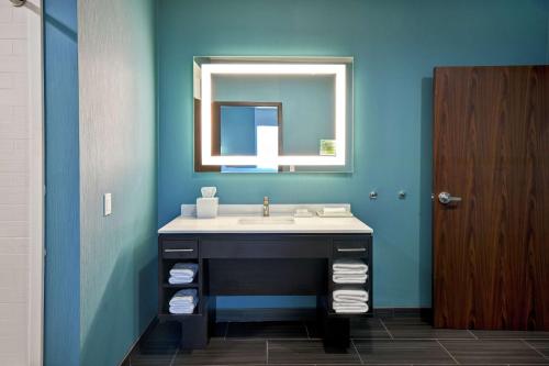 a bathroom with a sink and a mirror at Home2 Suites By Hilton El Reno in El Reno