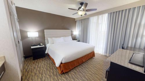 a hotel room with a bed and a window at Embassy Suites by Hilton Oklahoma City Will Rogers Airport in Oklahoma City