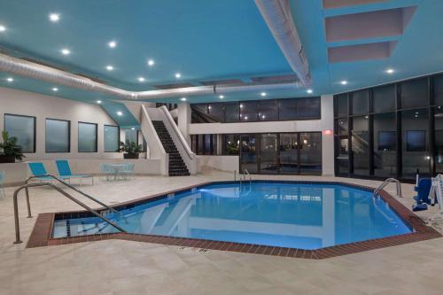 a large swimming pool in a building with a hotel at Embassy Suites By Hilton Oklahoma City Northwest in Oklahoma City