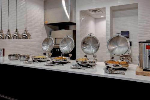 a kitchen with several bowls of food on a counter at Embassy Suites By Hilton Oklahoma City Northwest in Oklahoma City
