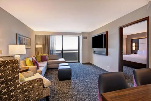 a hotel room with a couch and a bed at Embassy Suites By Hilton Oklahoma City Northwest in Oklahoma City