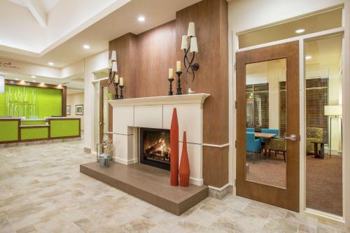 a lobby with a fireplace in the middle at Hilton Garden Inn Olympia, WA in Olympia