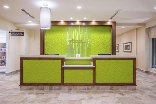 a lobby with a green wall in a store at Hilton Garden Inn Olympia, WA in Olympia