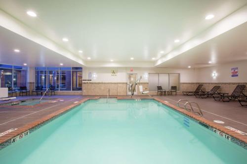 a large swimming pool with blue water in a building at Hilton Garden Inn Olympia, WA in Olympia