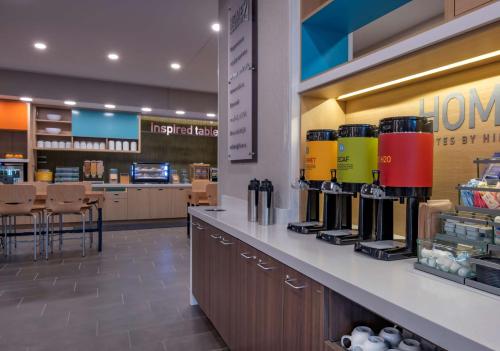 a store with a counter with wine bottles on it at Home2 Suites by Hilton Omaha I-80 at 72nd Street, NE in Omaha