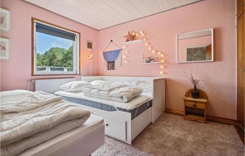 two beds in a room with pink walls at Lovely Home In Nordborg With Wifi in Nordborg