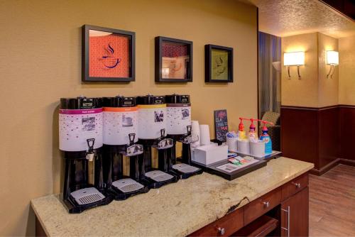 a counter with bottles of wine in a hotel room at Hampton Inn & Suites Ontario in Ontario